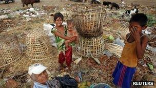 People search for usable items at a junkyard in Yangon, Burma May 16 2012