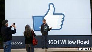 Xavier Schmidt of Menlo Park, has his picture taken by his parents outside Facebook"s headquarters in Menlo Park, California