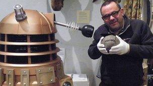 Huw Williams holds football as Dalek looks on