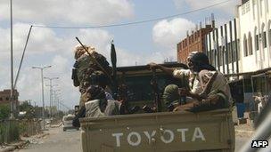 Yemeni militants, suspected of being members of Al-Qaeda patrol on a pick up in the restive southern city of Zinjibar in Yemen on 28 April 2012