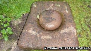 Picture of the bullaun sitting on the bowl-shaped lower stone on Canna