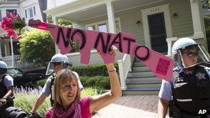 Anti-Nato demonstrator holds a sign in front of Chicago Mayor Rahm Emanuel's home, 19 May 2012