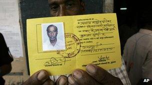 A fisherman holds an identity card in Mumbai