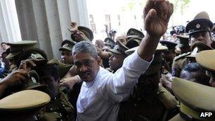 Sri Lanka's former army chief, Sarath Fonseka (C) waves to supporters as he arrives at the Colombo High Court in Colombo on November 18, 2011