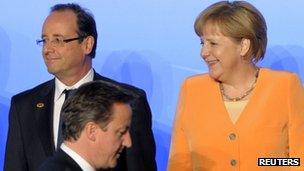 David Cameron passes Francois Hollande and Angela Merkel at the Nato summit in Chicago, 20 May