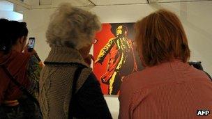 Women look at the painting "The Spear" by Brett Murray at the Goodman Gallery in Johannesburg on May 18, 2012