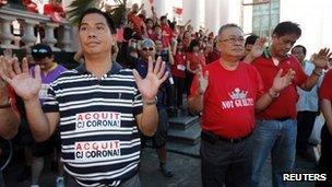 Supporters of Mr Corona attend an interfaith prayer session for him at the Supreme Court in Manila on Tuesday