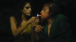 Eva Mendes and Denis Lavant in Holy Motors