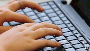 A person uses a laptop keyboard