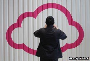 Visitor to German technology trade-fair photographing symbol of cloud