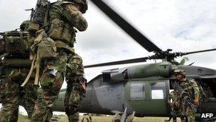 Airborne soldiers board a helicopter in Guerima, in the eastern province of Vichada, eastern plains of Colombia, on March 9, 2011