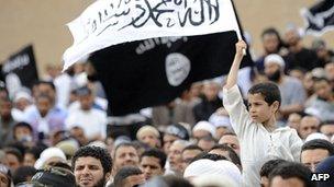 A young Tunisian boy holds a banner as Tunisian Salafist Muslims attend a rally in Kairouan (file image from 20 May 2012)