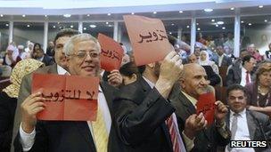 Delegates from the Green Algeria alliance, a grouping of moderate Islamist parties with links to the ruling establishment, hold up placards during the opening session of the new National Assembly in Algiers May 26, 2012