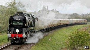 Steam train passes Corfe Castle