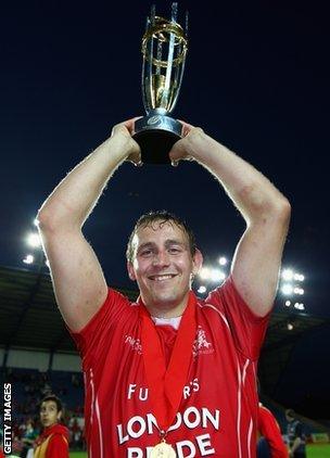 Jon Mills holds aloft the Championship trophy