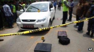 Nepalese police inspect the scene after Supreme Court judge Rana Bahadur Bam was shot and killed in Katmandu, Nepal, Thursday, May 31, 2012.