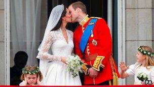 Prince William and his wife Kate Middleton, who has been given the title of The Duchess of Cambridge, kiss on the balcony of Buckingham Palace, London after their wedding