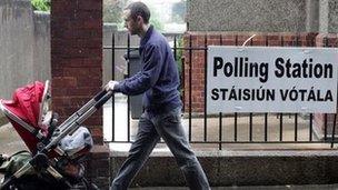 A man with a buggy passes a polling station in Drumcondra, Dublin, 31 May