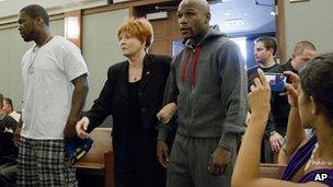 Floyd Mayweather Jr (right) walks into court escorted by his attorney Karen Winckler, center, and 50 Cent, left, to begin his 90-day jail term, June 1