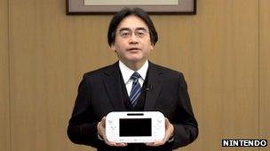 Satoru Iwata holding the Wii U gamepad