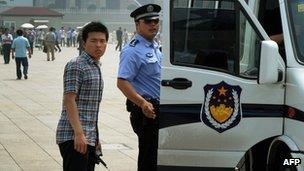 Police detain a man (R) in Tiananmen Square on the 23rd anniversary of China's crackdown of democracy protests, in Beijing on 4 June 2012