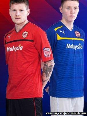 Midfielder Aron Gunnarsson in the new red home shirt and striker Joe Mason in Cardiff's new blue away strip.