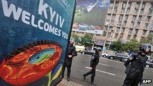 Riot police next to a Euro 2012 poster at an opposition demonstration in Kiev on 5/6/2012