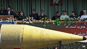 Iranian President Mahmoud Ahmadinejad at a parade with military officials in Tehran in September 2005