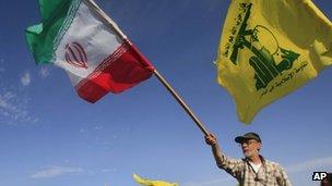 A man waves an Iranian flag at a Hezbollah rally in southern Lebanon on 25 May 2012