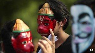 Members of a hacking group, Anonymous India, wear masks of Hanuman, Indian monkey headed god, along with masks of Guy Fawkes