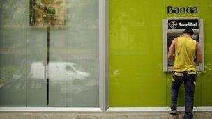 A file picture taken on May 17, 2012 shows a man using a Bankia ATM machine in Madrid.