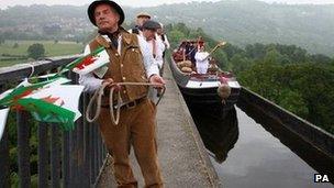 The torch relay travels by canal along the Pontcysyllte Aqueduct