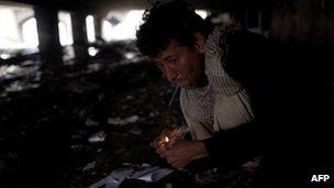 A man smokes heroin under a bridge in Kabul, Afghanistan 25 April 2012