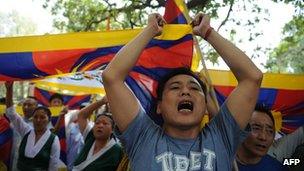 A man joins others in voicing opposition to Chinese government intervention in Tibet during a protest in New Delhi