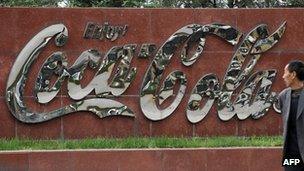 A man walks by a Coca-Cola plant in Taiyuan, northeast China's Shanxi province 30 April 2012