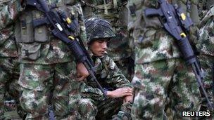 A soldier sits before an inauguration ceremony at Tolemaida Air Base, 13 June 2012