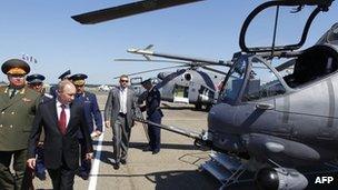 Russia's President Vladimir Putin (2nd L) looks at Mi-24 ground-attack helicopters as he visits a military airbase in the city of Korenovsk June 14, 2012