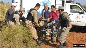 An injured policeman is taken from the scene of the clashes