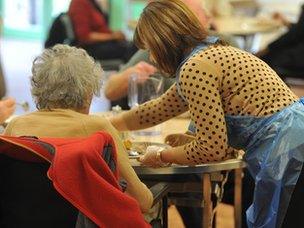 Care worker helping an elderly woman