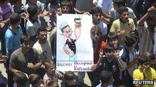 Demonstrators protest against Russia, China and Syria"s President Bashar al-Assad after Friday prayers in Kafranbel