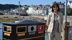 Guernsey States recycling officer Tina Norman-Ross next to a recycling bin in St Peter Port