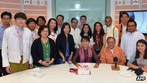 Aung San Suu Kyi poses for a photograph with staff at the BBC Burmese Service during her visit to BBC Broadcasting House on Tuesday