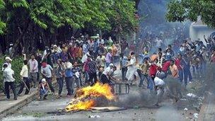 Garment workers throw pieces of bricks during clashes with police in Kanchpur, Dhaka June 16, 2012