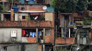 Stacked shack-like homes with satellite dishes in Rocinha