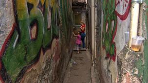 Mother and daughter in a narrow alley