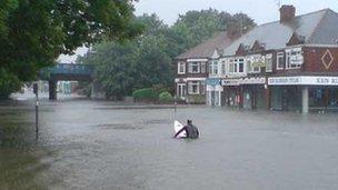 Man on surfboard in flooded Hull street