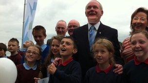 Martin McGuinness launching balloons with schoolchildren