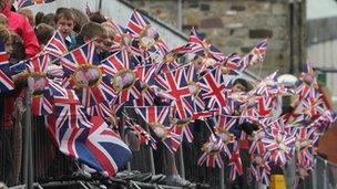 Crowd waving Union flags