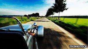 Car being driven along a road