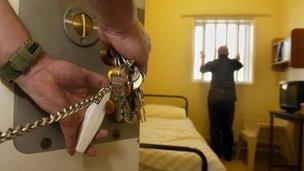 Prisoner in cell as warder locks the door